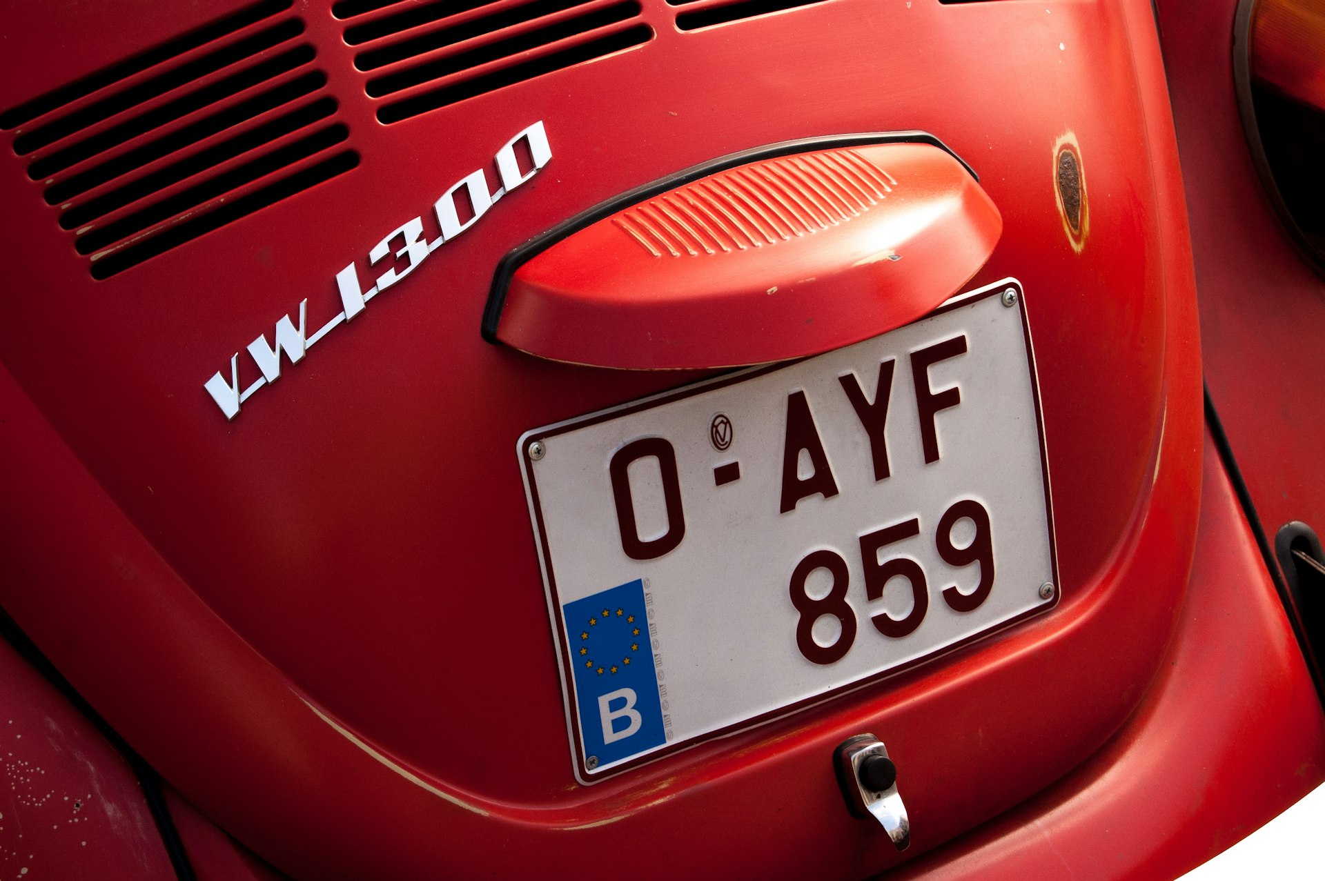 a close up of a red car with a license plate